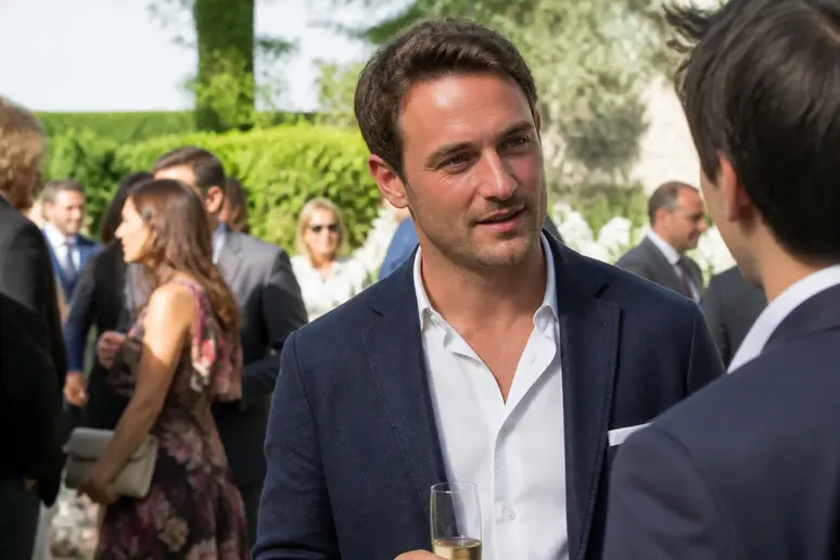 Un invité en blazer bleu marine en lin adapté à un mariage champêtre en plein air